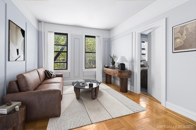 living area featuring baseboards