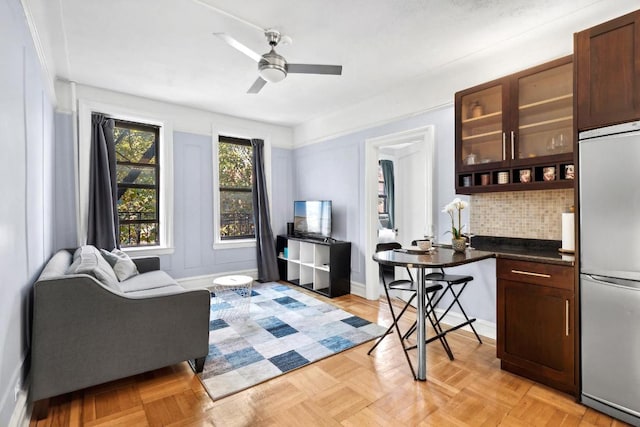 interior space with light parquet flooring and ceiling fan