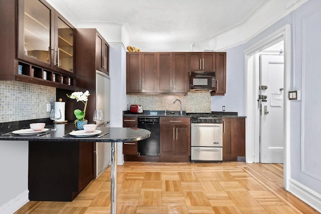 kitchen with light parquet flooring, a breakfast bar, dark brown cabinetry, and black appliances