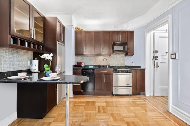 1 Minetta St Unit 5B, New York City, NY 10012 - kitchen with black appliances, dark countertops, tasteful backsplash, glass insert cabinets, and a sink