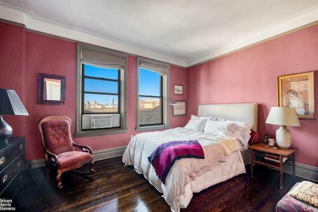 bedroom with hardwood / wood-style flooring, crown molding, baseboards, and cooling unit