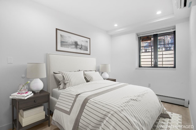 bedroom featuring a baseboard heating unit and recessed lighting