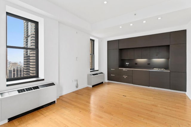 walk in closet with light hardwood / wood-style floors