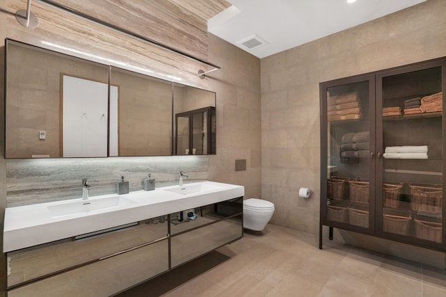 88 Lexington Ave Unit 1506, New York City, NY 10016 - full bathroom featuring tile walls, double vanity, and tile patterned floors
