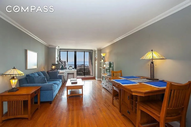 interior space with expansive windows, crown molding, and wood finished floors