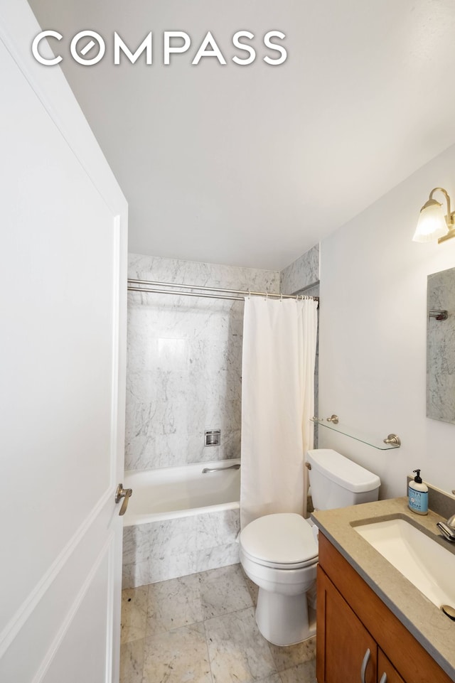 bathroom featuring tiled shower / bath, toilet, and vanity