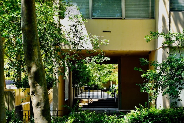 view of exterior entry featuring fence