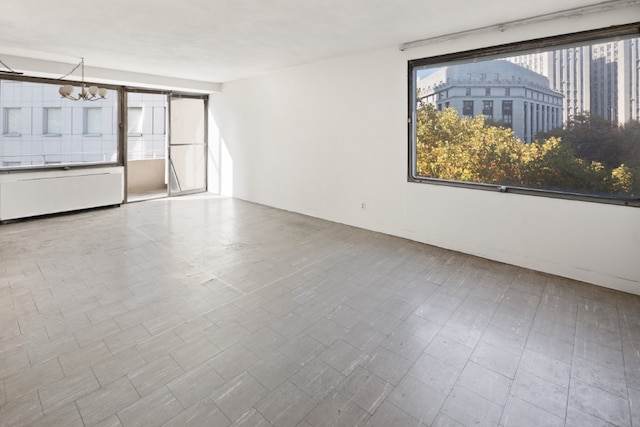 empty room featuring a notable chandelier