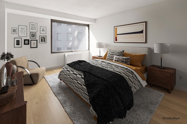 bedroom featuring wood finished floors and baseboards