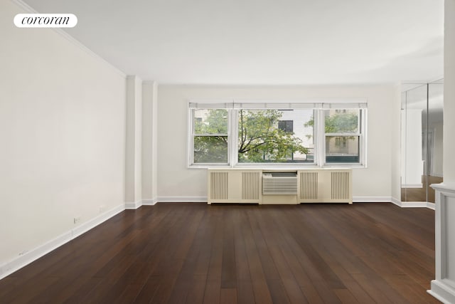 interior space with radiator and dark hardwood / wood-style floors