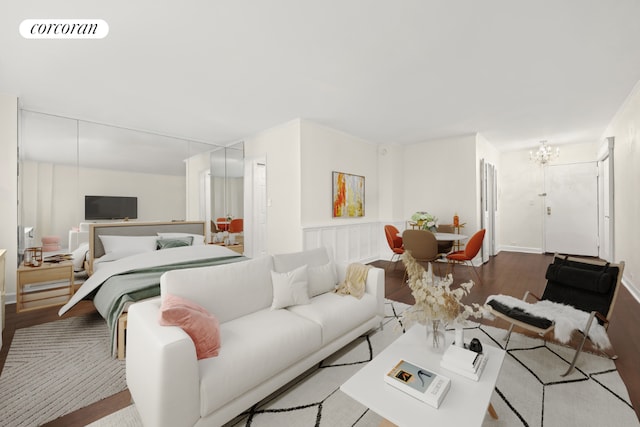 bedroom featuring a notable chandelier and light hardwood / wood-style floors