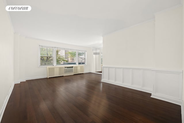 unfurnished living room with ornamental molding, radiator heating unit, and dark hardwood / wood-style flooring