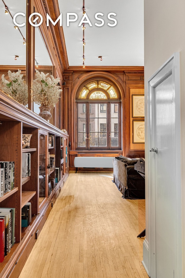 interior space with ornamental molding and hardwood / wood-style flooring