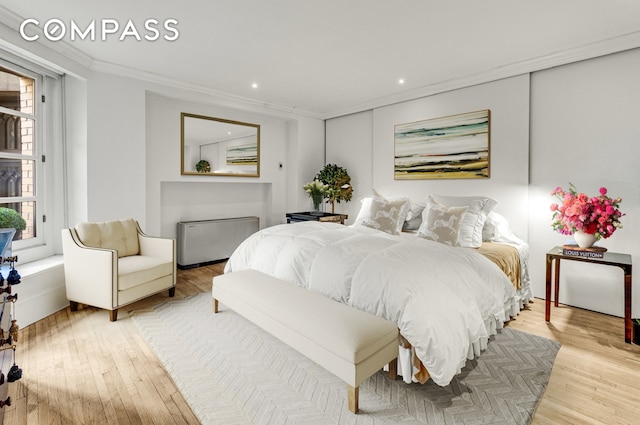 bedroom with crown molding, recessed lighting, light wood-style flooring, and radiator