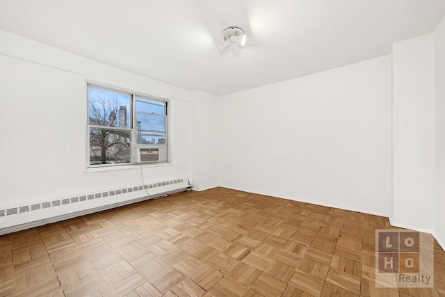 unfurnished room with a baseboard radiator and cooling unit