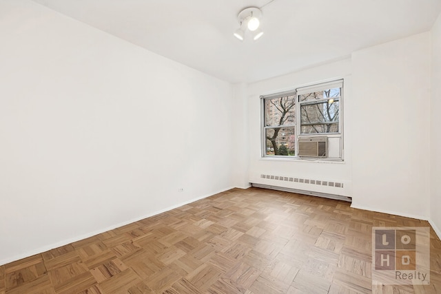 empty room with cooling unit, radiator, baseboards, and a baseboard radiator