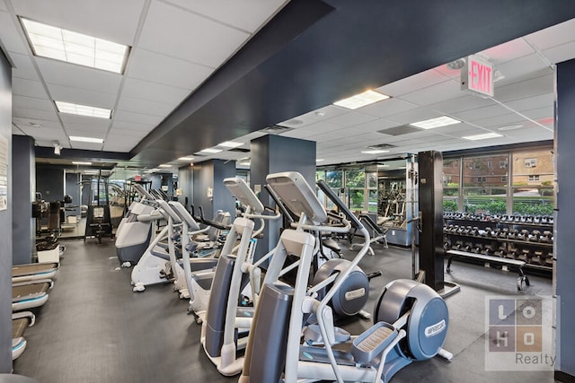 gym with a paneled ceiling