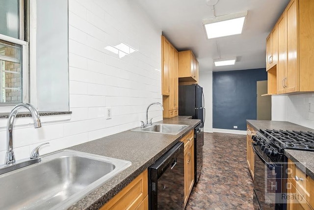 kitchen featuring dark countertops, black appliances, decorative backsplash, and a sink