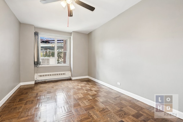 unfurnished room with radiator heating unit, a ceiling fan, and baseboards