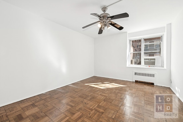 empty room with ceiling fan, cooling unit, and radiator