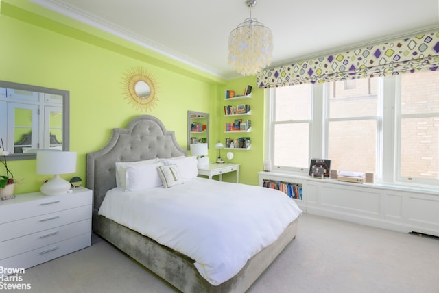 bedroom featuring a notable chandelier, ornamental molding, and carpet