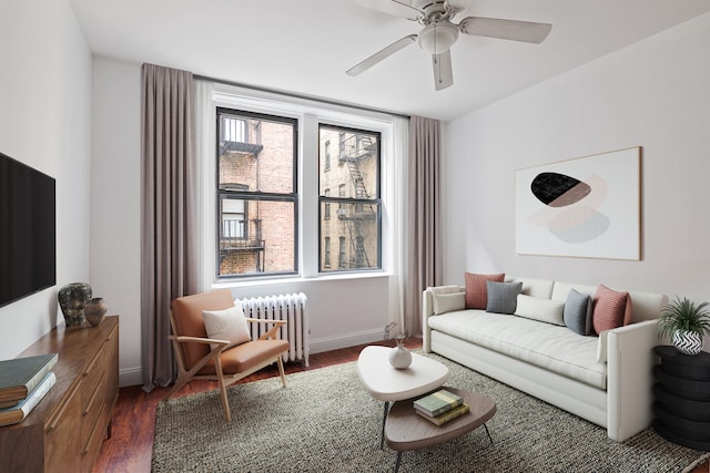 living room featuring a ceiling fan, baseboards, radiator heating unit, and wood finished floors