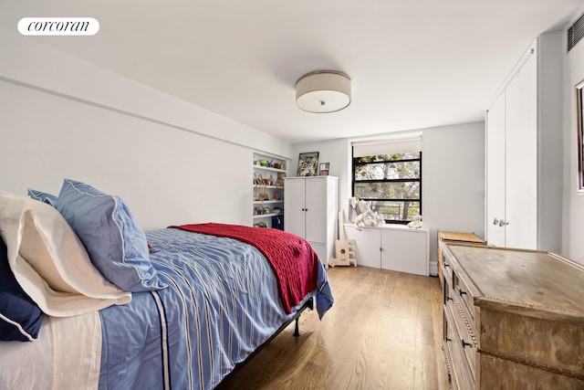 bedroom featuring visible vents and light wood-type flooring