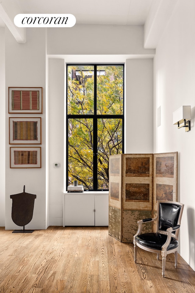 living area featuring visible vents and wood finished floors