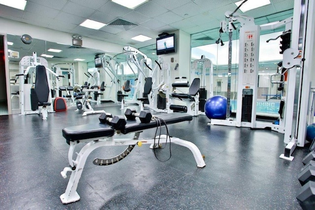 exercise room with a paneled ceiling