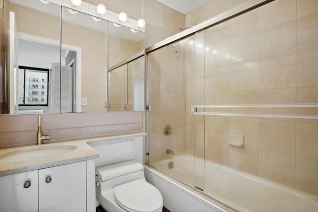 full bath featuring toilet, vanity, and tiled shower / bath combo