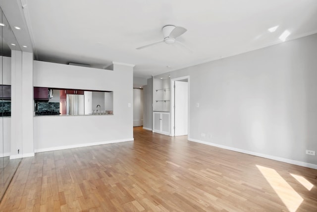 unfurnished living room with a ceiling fan, light wood-type flooring, a sink, baseboards, and recessed lighting