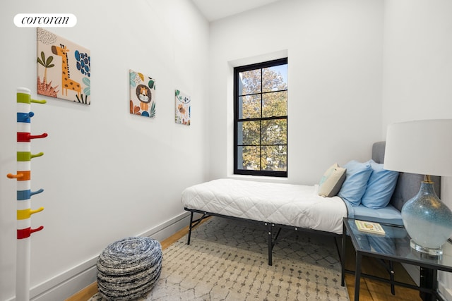 bedroom with baseboards and wood finished floors