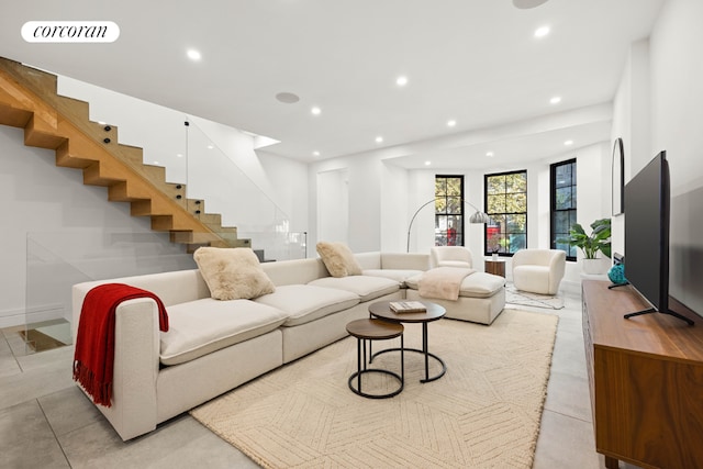 living room with stairs, visible vents, and recessed lighting