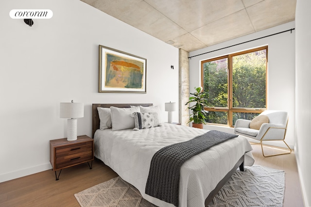 bedroom featuring visible vents, wood finished floors, and baseboards