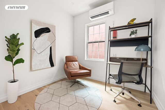 office featuring an AC wall unit and wood-type flooring