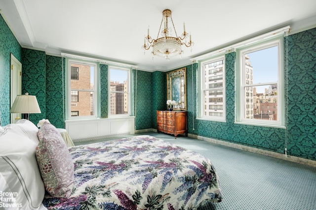 carpeted bedroom with wallpapered walls, ornamental molding, baseboards, and a chandelier