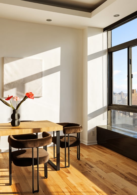 dining space featuring light hardwood / wood-style flooring, expansive windows, and a healthy amount of sunlight