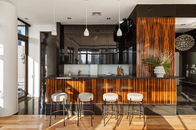 bar with a wall of windows, backsplash, and pendant lighting