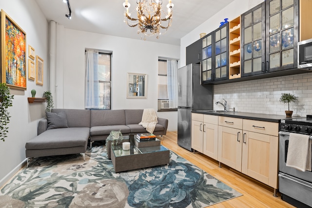 living area featuring an inviting chandelier and light wood-style flooring