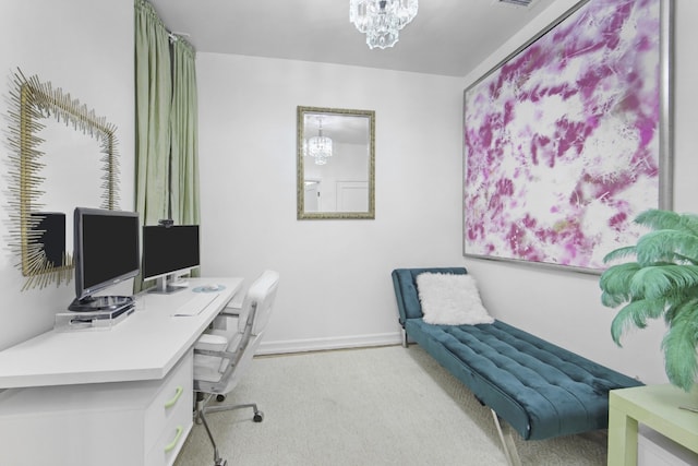 carpeted home office with a chandelier