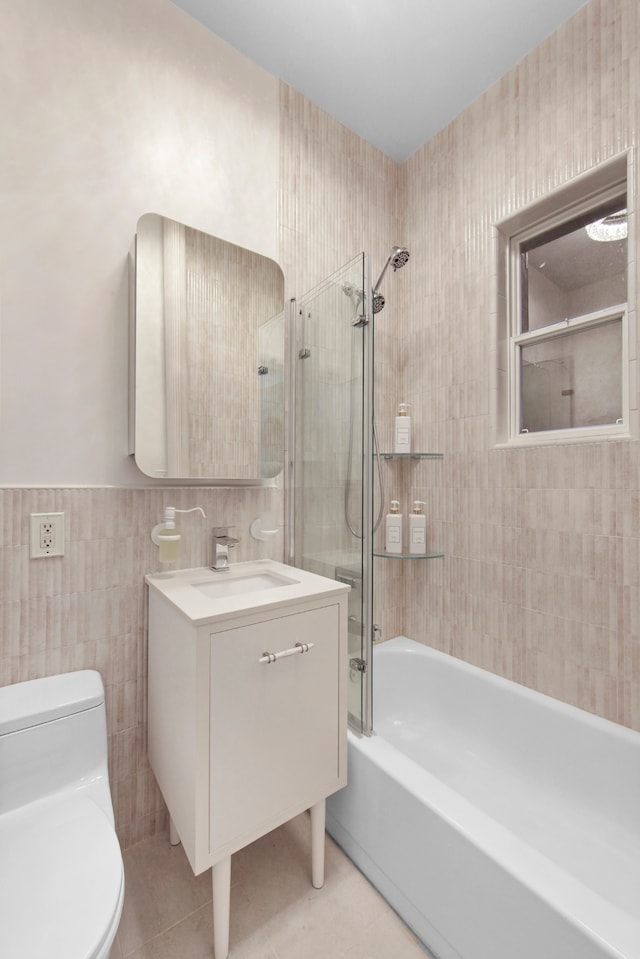 237 E 88th St Unit 101, New York City, NY 10128 - full bath with tile walls, vanity, shower / tub combination, tile patterned flooring, and a wainscoted wall