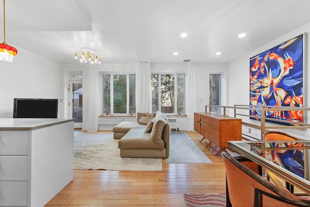 living room with light hardwood / wood-style flooring and radiator heating unit