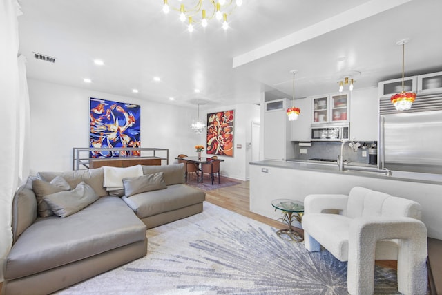 237 E 88th St Unit 101, New York City, NY 10128 - living area featuring light wood finished floors, recessed lighting, and a chandelier