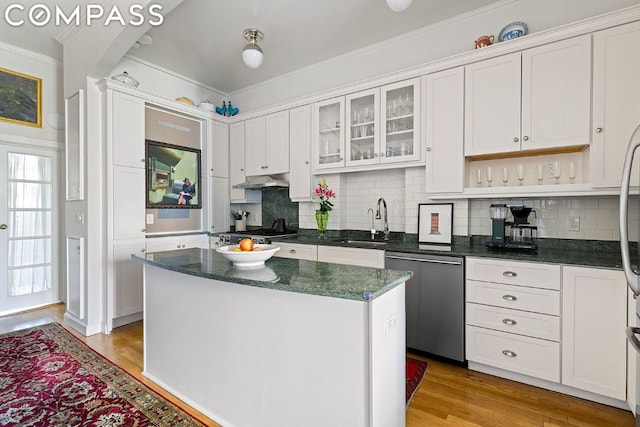 kitchen featuring dishwasher, a kitchen island, sink, and white cabinets