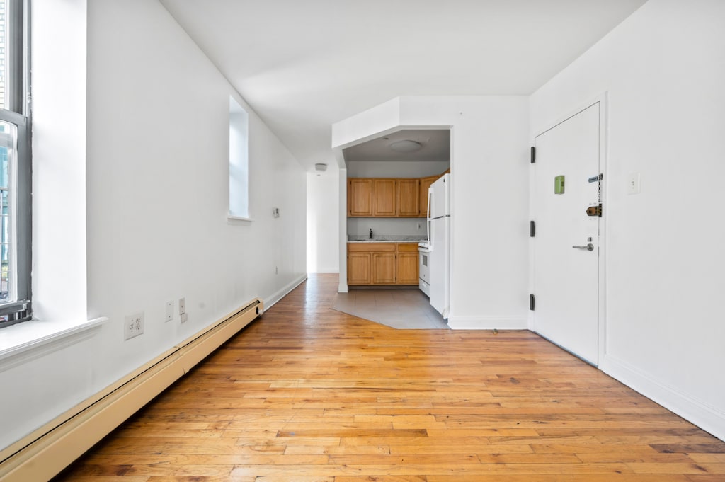 interior space featuring light hardwood / wood-style floors and a baseboard radiator