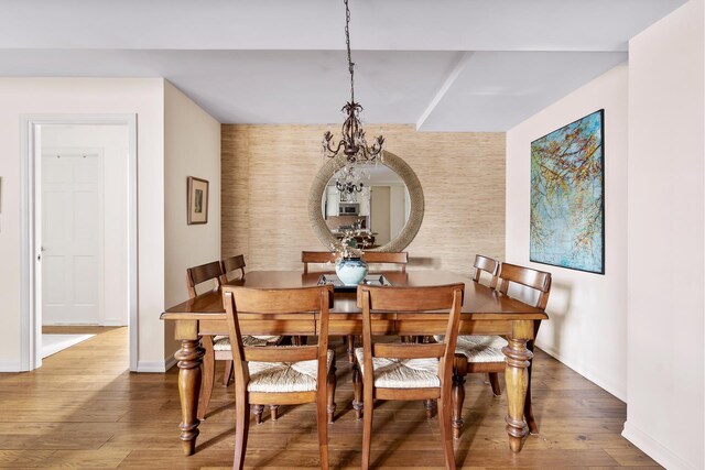 339 E 58th St Unit 7Cd, New York City, NY 10022 - dining space with a chandelier, wood finished floors, and baseboards