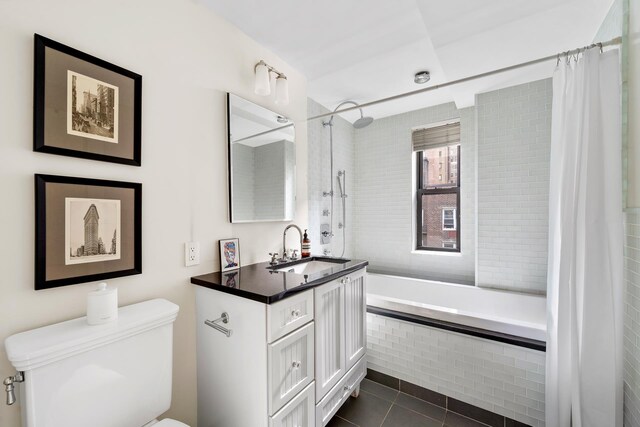 339 E 58th St Unit 7Cd, New York City, NY 10022 - bathroom with tile patterned flooring, tiled shower / bath combo, toilet, and vanity