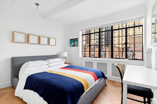 bedroom with beam ceiling and parquet flooring