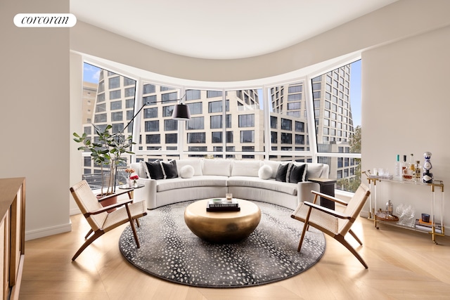 living area featuring parquet floors and baseboards