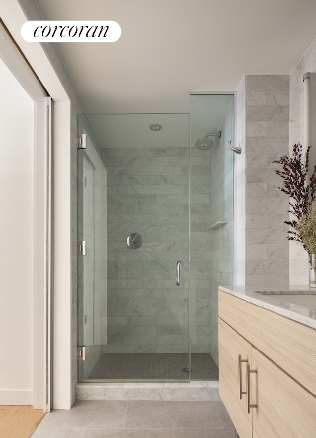 full bathroom with visible vents, a shower stall, and vanity